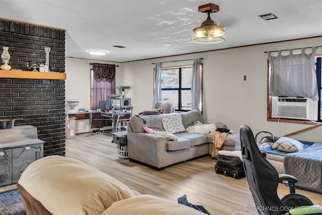 living room featuring light hardwood / wood-style flooring and cooling unit