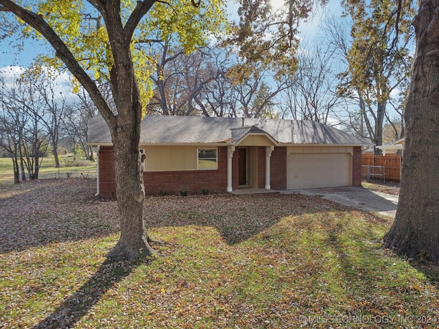 ranch-style home with a garage and a front yard