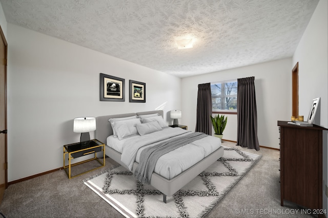 bedroom with light colored carpet and a textured ceiling