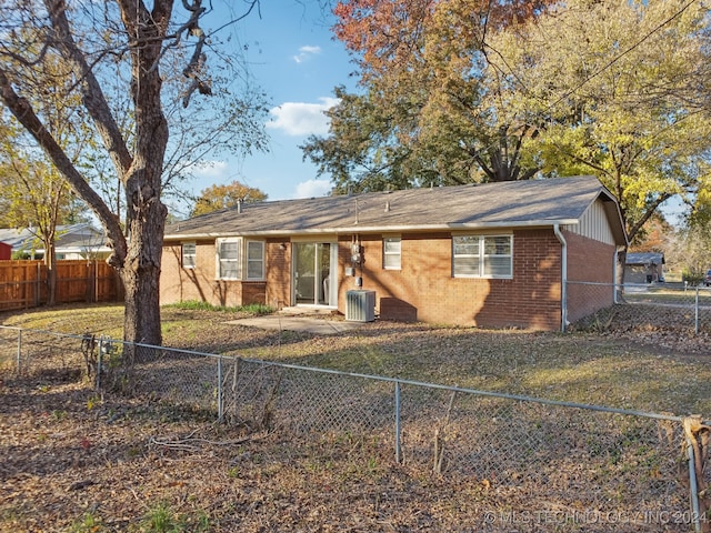 back of house featuring a yard and cooling unit