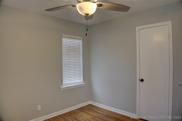 unfurnished room with ceiling fan and hardwood / wood-style flooring