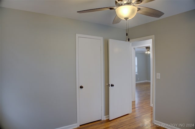 unfurnished bedroom with ceiling fan and light hardwood / wood-style flooring