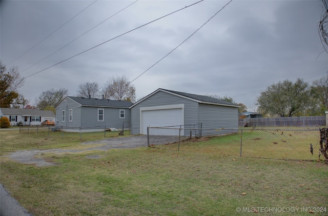 exterior space with a yard, an outbuilding, and a garage