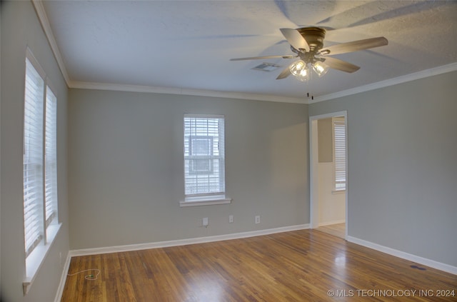 spare room featuring hardwood / wood-style floors, ceiling fan, and ornamental molding