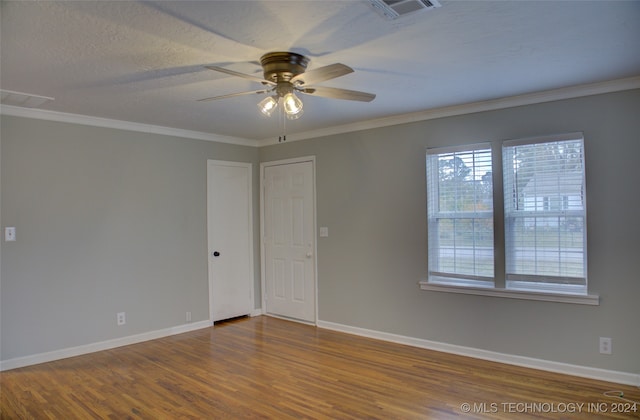 empty room featuring hardwood / wood-style floors, ceiling fan, crown molding, and a textured ceiling