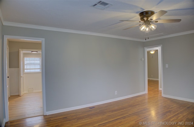 spare room with wood-type flooring, ceiling fan, and crown molding