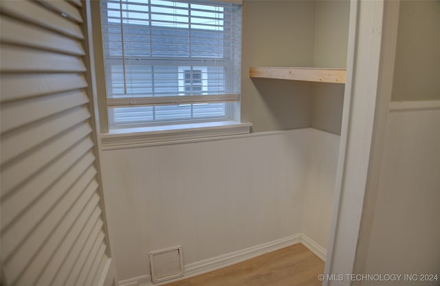 laundry room with wood-type flooring