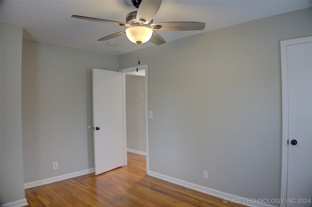 empty room with ceiling fan and wood-type flooring