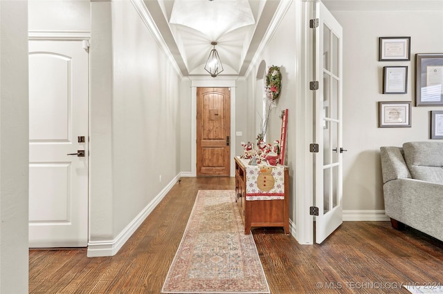 interior space featuring crown molding, dark hardwood / wood-style flooring, and a notable chandelier