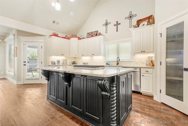 kitchen featuring white cabinets, dishwasher, a kitchen island, and hardwood / wood-style flooring