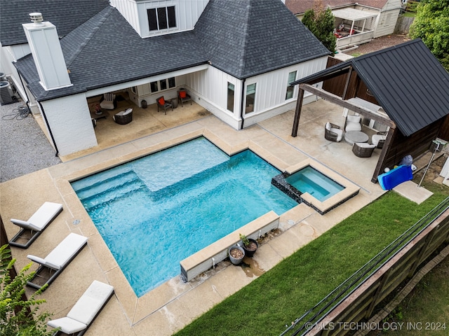 view of swimming pool with a gazebo, an in ground hot tub, a patio, and an outdoor hangout area