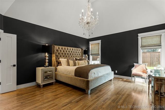 bedroom featuring hardwood / wood-style floors, high vaulted ceiling, and an inviting chandelier