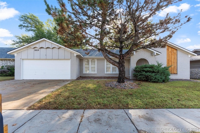 ranch-style home with a front lawn and a garage