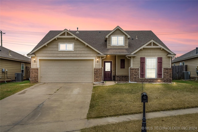 craftsman house with a garage, cooling unit, and a lawn