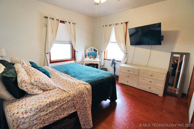 bedroom with dark hardwood / wood-style flooring