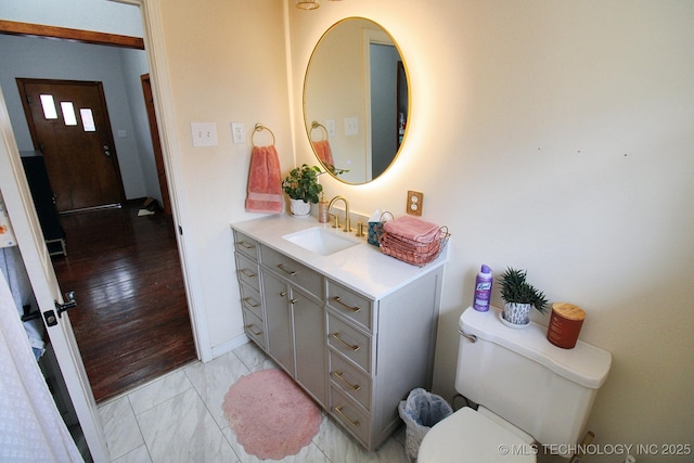 bathroom featuring vanity and toilet