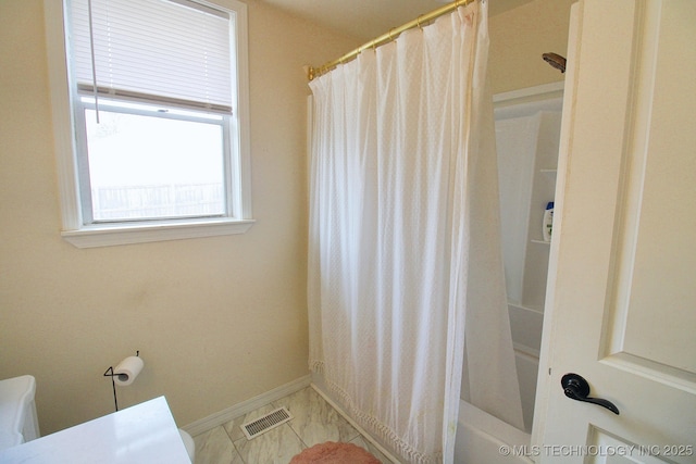 bathroom with tile patterned flooring and shower / bath combo