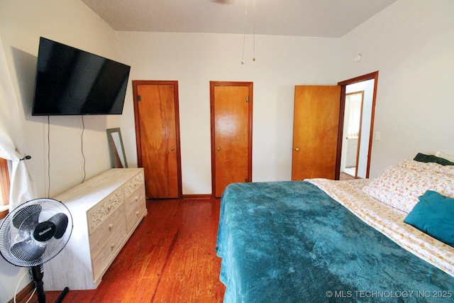 bedroom with dark hardwood / wood-style flooring