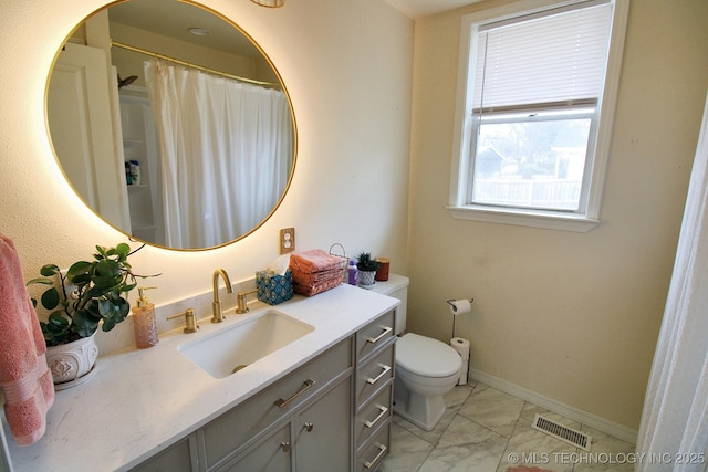 bathroom with vanity and toilet