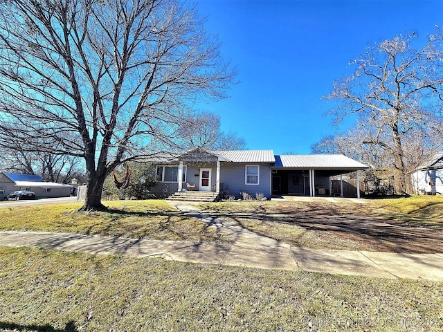 ranch-style house featuring a front yard and a carport