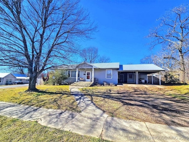 ranch-style house featuring a front lawn and a carport