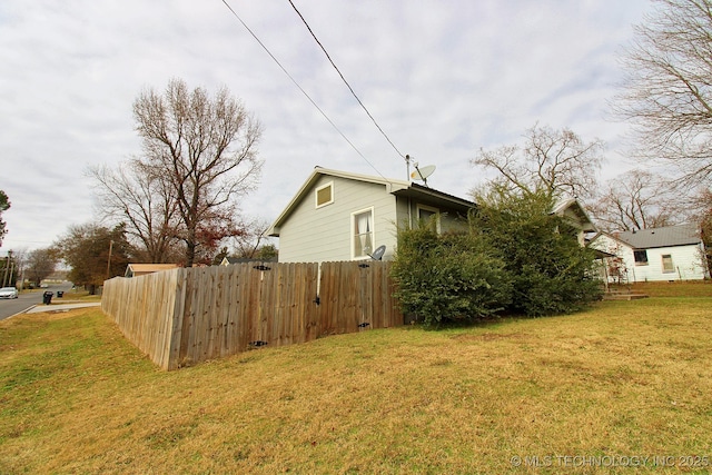 view of side of property with a yard