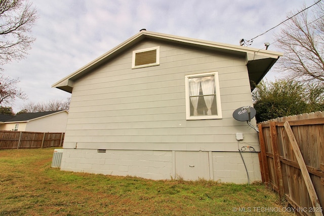 view of side of home with a lawn