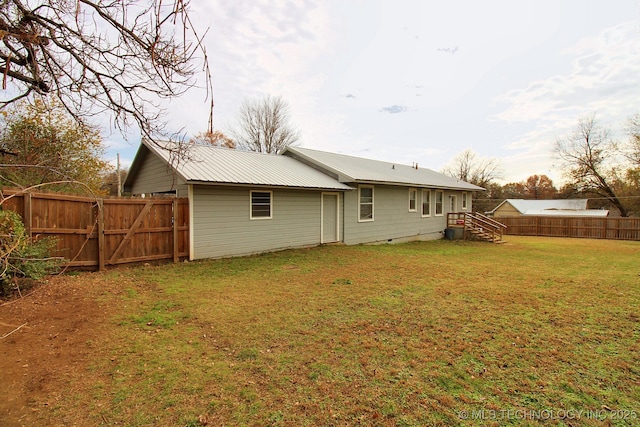 back of property with a lawn