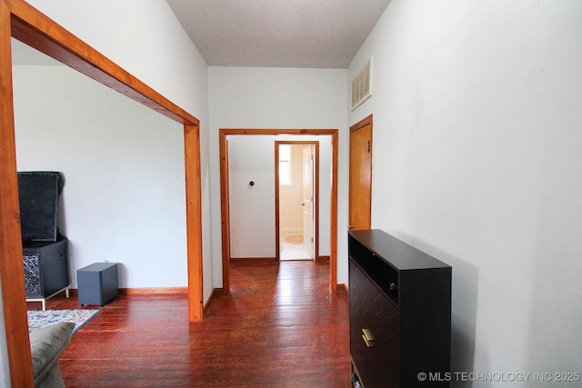 corridor featuring dark hardwood / wood-style floors