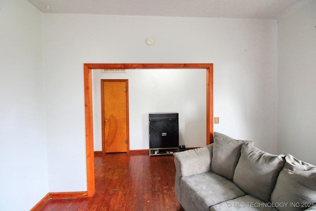 unfurnished living room featuring dark hardwood / wood-style flooring