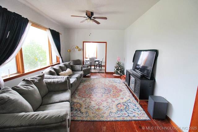 living room with ceiling fan and dark hardwood / wood-style flooring