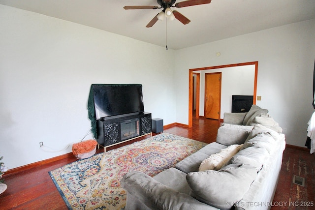 living room with dark hardwood / wood-style floors and ceiling fan