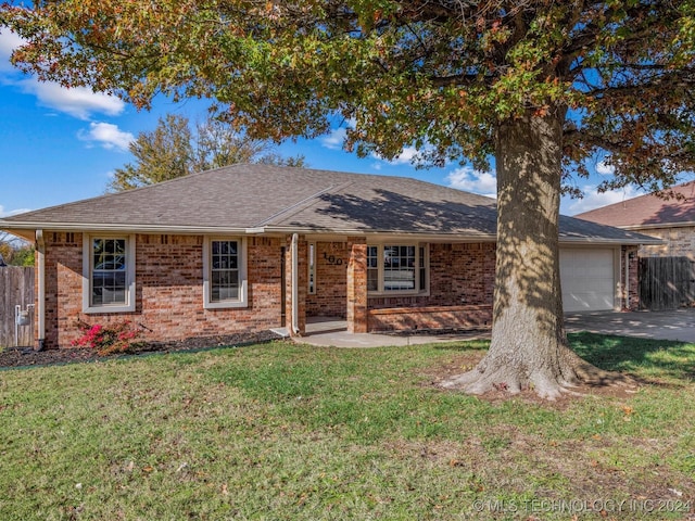 ranch-style house with a front lawn and a garage