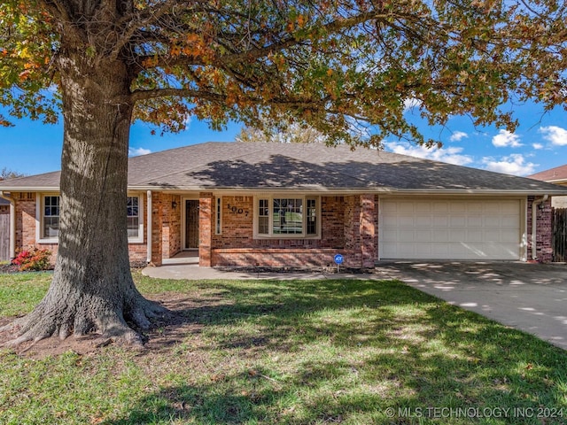 ranch-style house featuring a garage and a front lawn