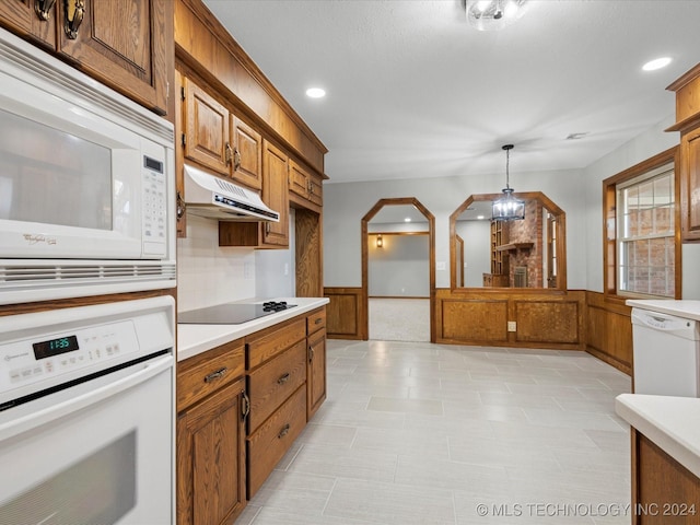 kitchen featuring pendant lighting and white appliances