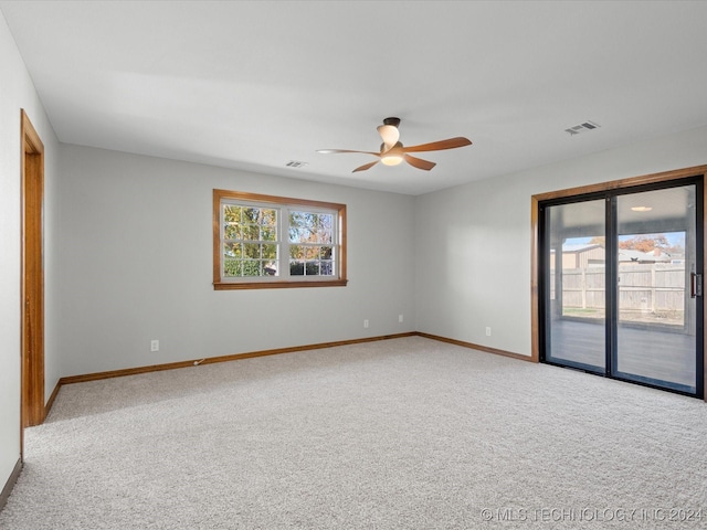 carpeted spare room with ceiling fan