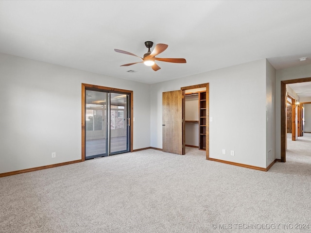 carpeted spare room with ceiling fan