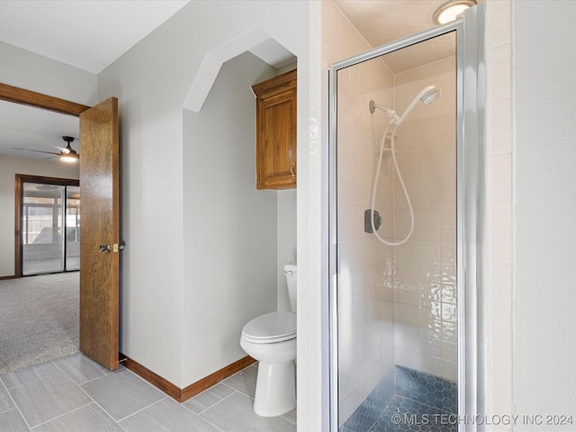 bathroom featuring tile patterned flooring, ceiling fan, toilet, and walk in shower