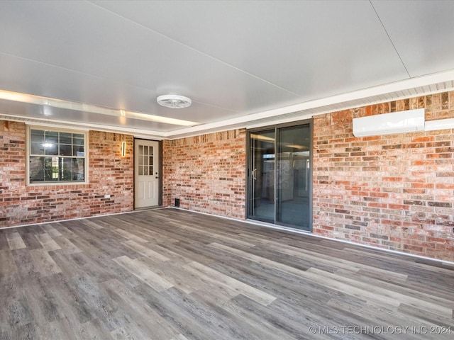 wooden deck featuring a wall unit AC