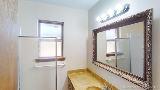 bathroom featuring vanity and a shower with shower door