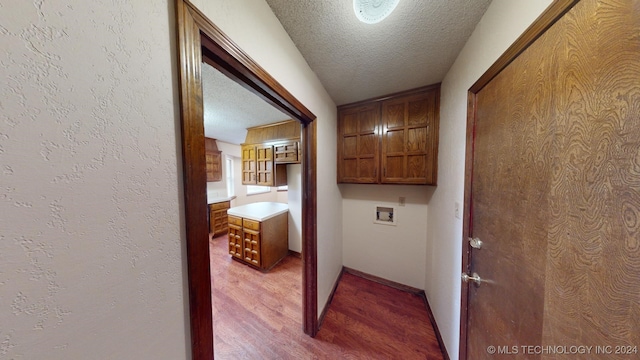 hall featuring hardwood / wood-style floors and a textured ceiling