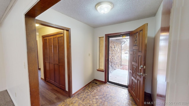 entryway featuring a textured ceiling