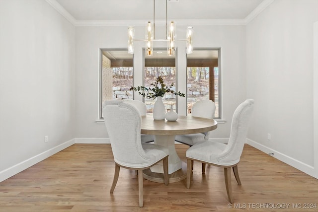 dining room featuring a notable chandelier, crown molding, and light wood-type flooring