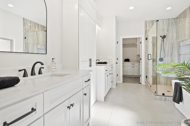 bathroom with vanity, an enclosed shower, and tile patterned floors