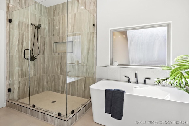 bathroom with plus walk in shower, sink, and decorative backsplash