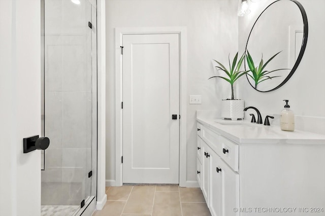 bathroom with tile patterned flooring, vanity, and a shower with shower door