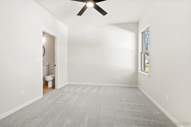 unfurnished room featuring light colored carpet and ceiling fan