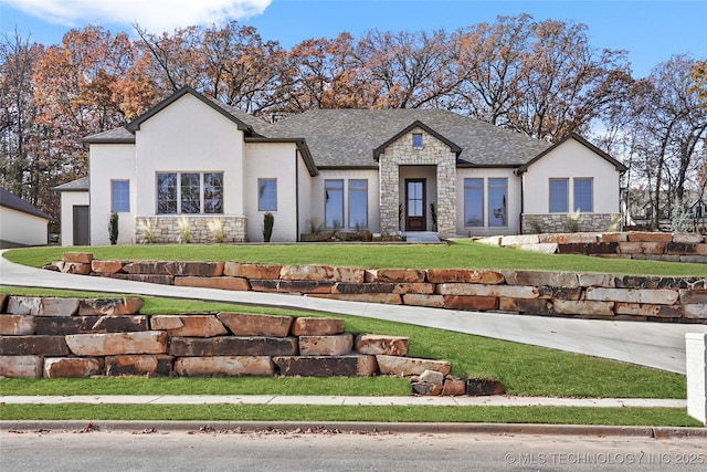 view of front of home featuring a garage and a front lawn