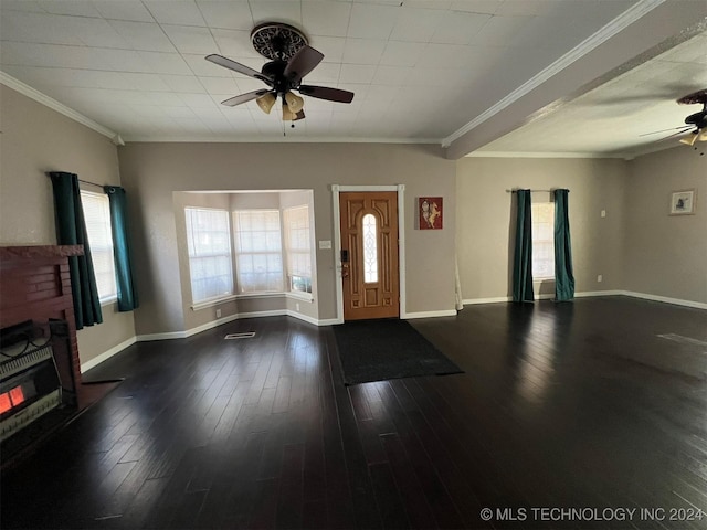 foyer entrance with ornamental molding, dark hardwood / wood-style floors, ceiling fan, and a healthy amount of sunlight