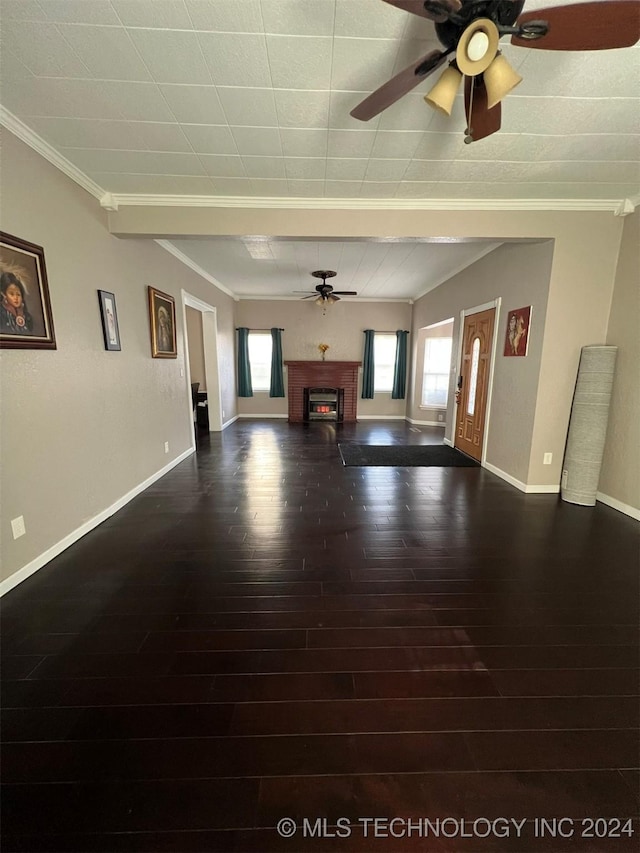 unfurnished living room featuring dark hardwood / wood-style floors, ceiling fan, and ornamental molding